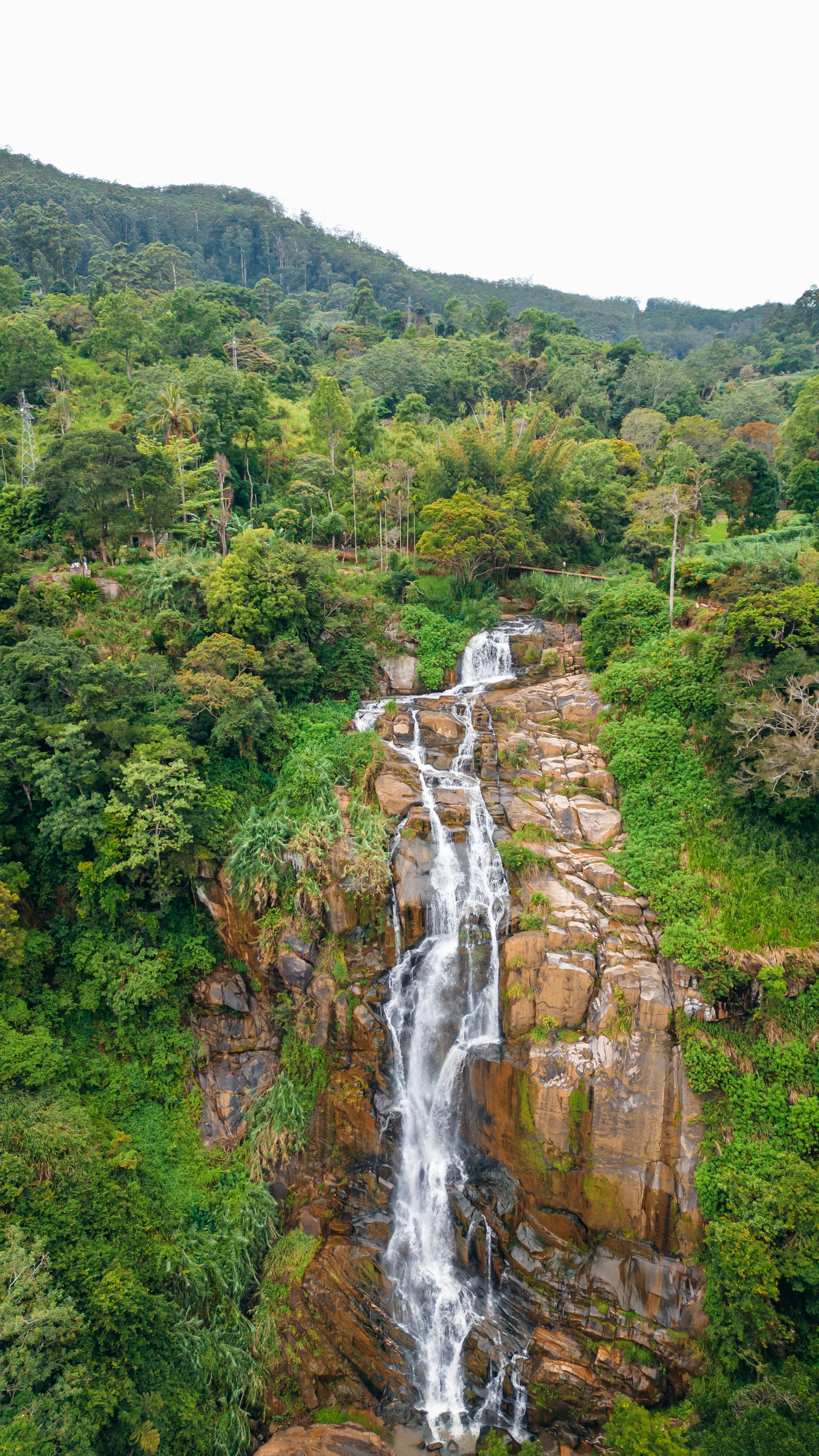 Tall waterfall cascading through tropical jungle rainforest in Sri Lanka