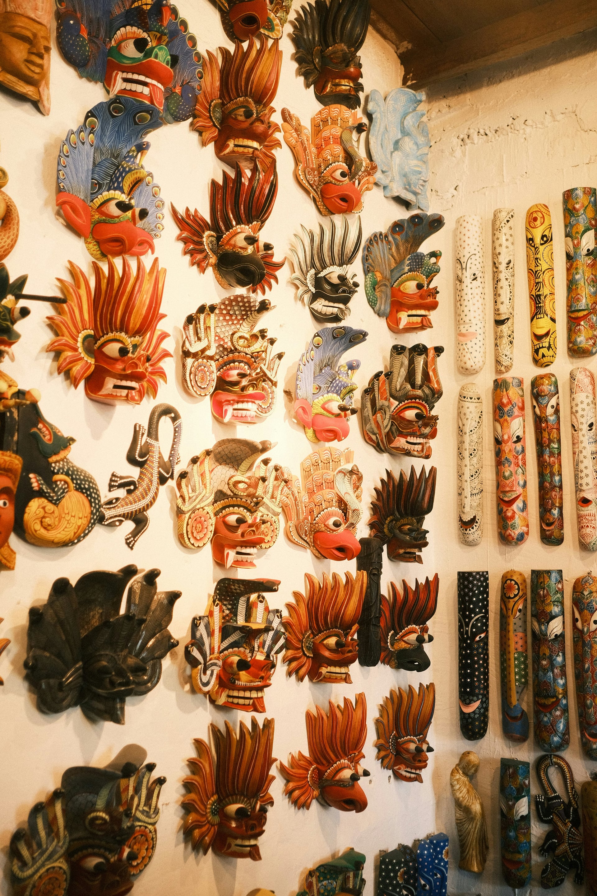 Traditional Sri Lankan devil masks displayed at a roadside craft shop