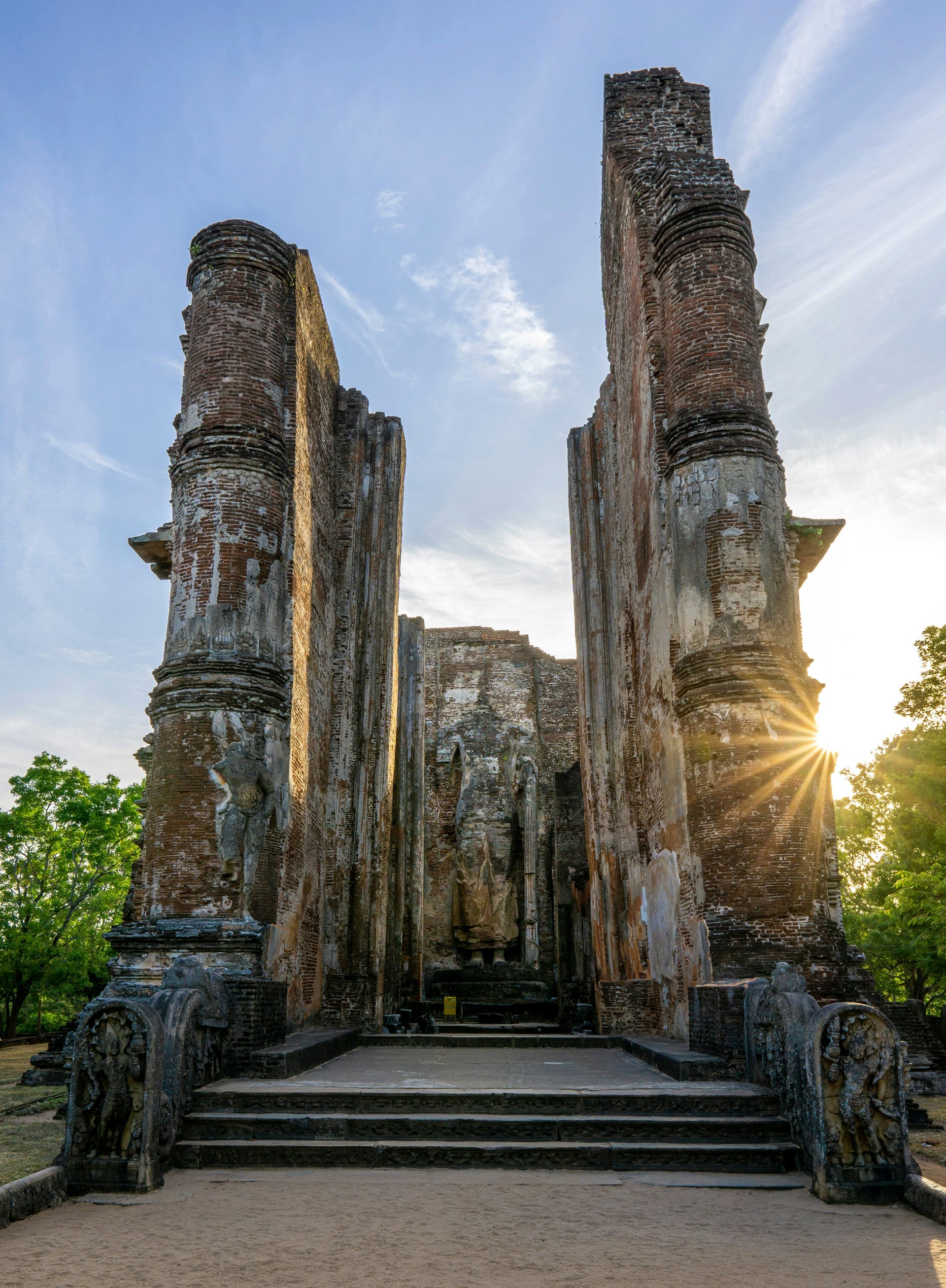 Lankatilaka temple ruins at Polonnaruwa with dramatic sun starburst