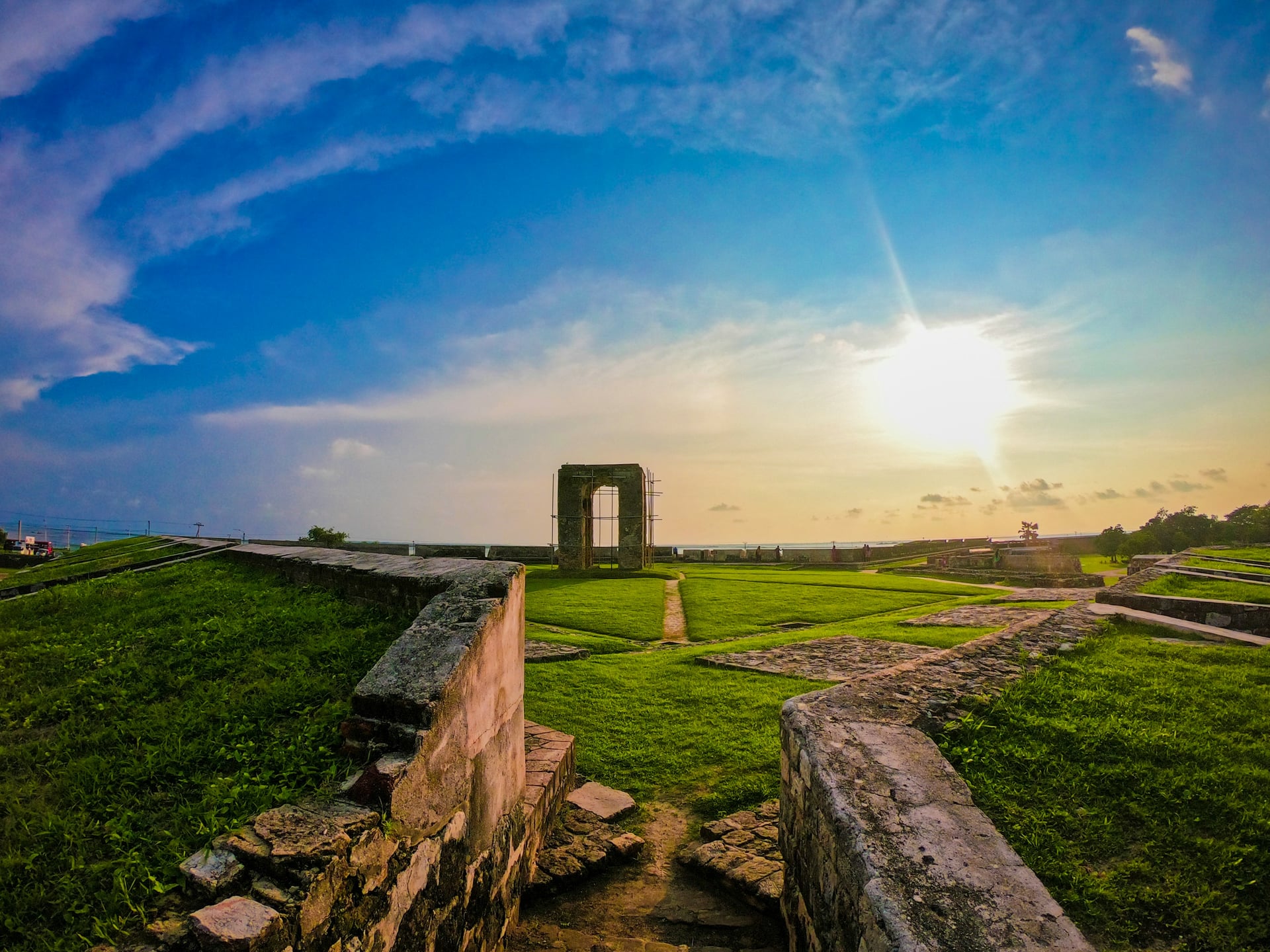 Galle Fort ramparts stone archway glowing orange at sunset