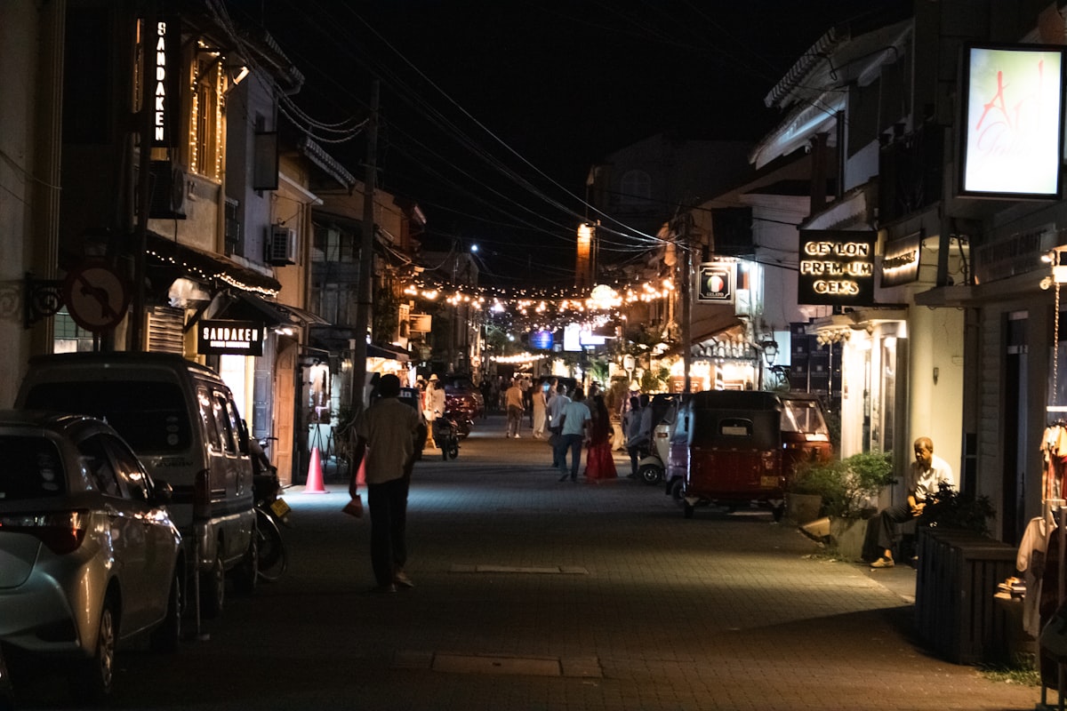 Night street scene inside Galle Fort with shops, cafes and string lights