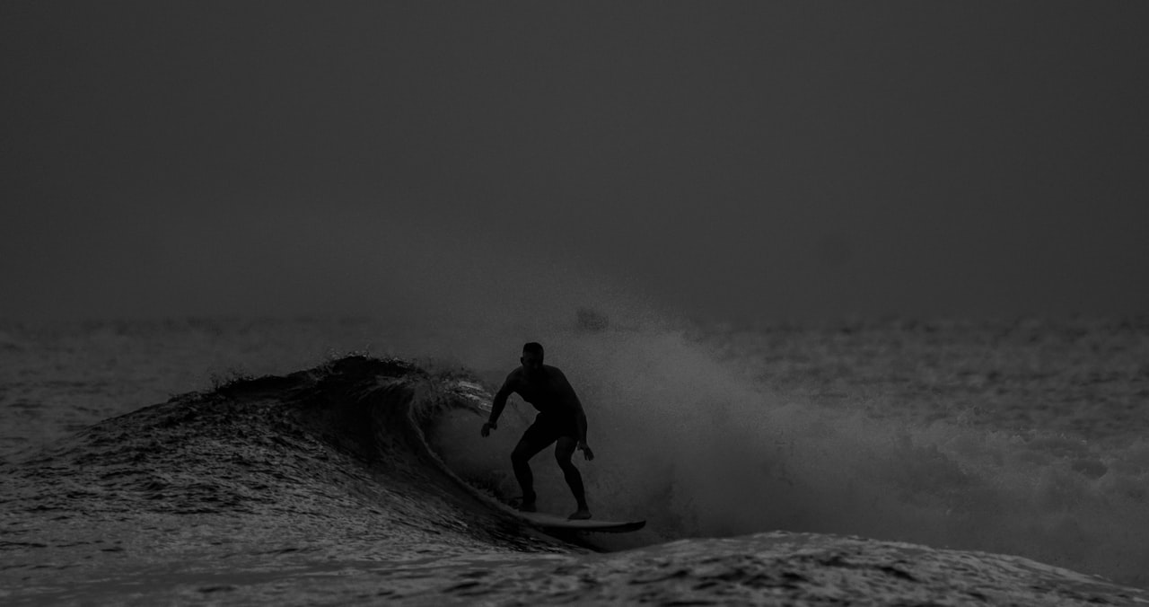 A surfer riding a wave at Hikkaduwa beach