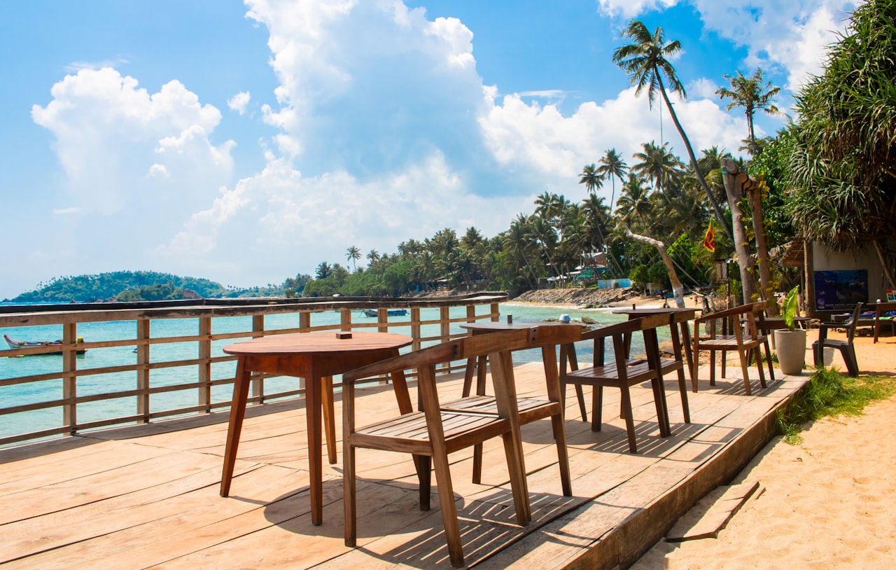 Beachside restaurants and colourful boats along Hikkaduwa's main beach strip