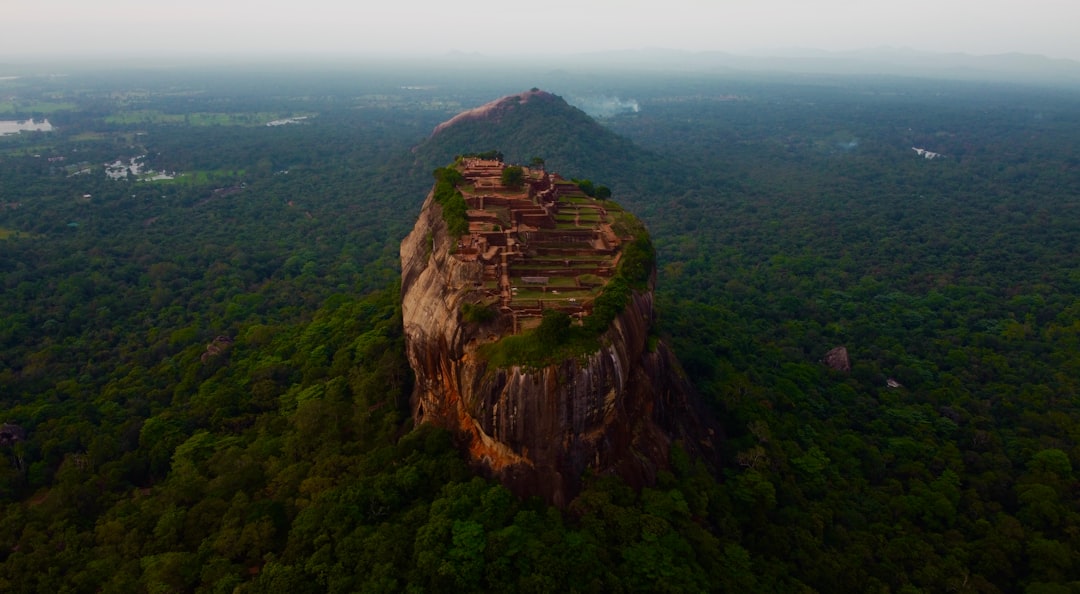 The ornate carved stone stairway ascending the towering Yapahuwa Rock Fortress in Sri Lanka